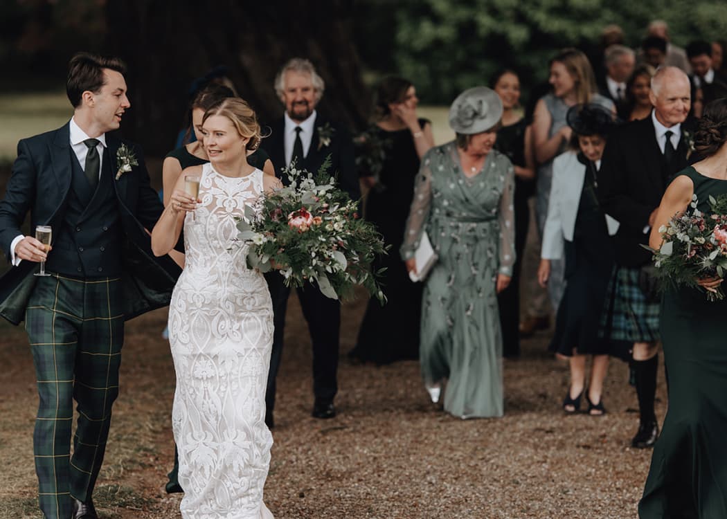 James and Lauren, and guests, walking to the reception